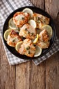 Italian cuisine: chicken piccata with sauce close-up on the table. Vertical top view Royalty Free Stock Photo