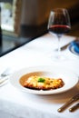 Italian cuisine dish lasagna with a glass of red wine