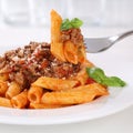 Italian cuisine eating Penne Rigatoni Bolognese sauce noodles pa Royalty Free Stock Photo