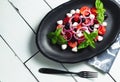 Italian cuisine. Fresh Italian Caprese salad with mozzarella and tomatoes on dark plate on white wooden table. Top view Royalty Free Stock Photo
