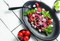 Italian cuisine. Fresh Italian Caprese salad with mozzarella and tomatoes on dark plate on white wooden table. Top view Royalty Free Stock Photo