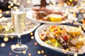 Italian cuisine. Glass of prosecco and variety of seafood with gentle festive holiday bokeh