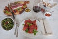 Italian cuisine: meat stew ragÃÂ¹ napoletano with basil, broccoli, speck, salami, olives, bread, chilli sauce and red wine