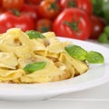 Italian cuisine pasta Tortellini noodles meal with tomatoes on p Royalty Free Stock Photo