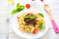 Italian cuisine penne bolognese or Bolognaise sauce noodles pasta meal on a plate on white wood Royalty Free Stock Photo