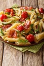 Italian cuisine: penne pasta with fried prosciutto, cherry tomatoes, zucchini and cheese close-up. vertical Royalty Free Stock Photo