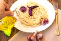 Italian cuisine, spaghetti with Basil and garlic, a woman& x27;s hand holding a glass jug of olive oil Royalty Free Stock Photo