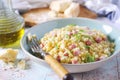 Italian Cuisine. Stortini pasta risotto with fresh ham cubes, parmesan cheese and olive oil Royalty Free Stock Photo