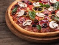 Italian delicious pizza with mushrooms and ham