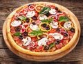 Italian delicious pizza with mushrooms and ham on the old boards Royalty Free Stock Photo