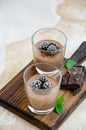 Italian dessert - chocolate panna cotta, mousse, cream or pudding with blackberry in a glass on a board Royalty Free Stock Photo