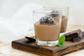 Italian dessert - chocolate panna cotta, mousse, cream or pudding with blackberry in a glass on a board Royalty Free Stock Photo