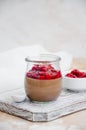 Italian dessert - chocolate panna cotta, mousse, cream or pudding with cherry sauce in a glass jar on a board Royalty Free Stock Photo