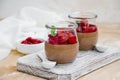 Italian dessert - chocolate panna cotta, mousse, cream or pudding with cherry sauce in a glass jar on a board Royalty Free Stock Photo