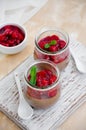 Italian dessert - chocolate panna cotta, mousse, cream or pudding with cherry sauce in a glass jar on a board Royalty Free Stock Photo