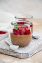 Italian dessert - chocolate panna cotta, mousse, cream or pudding with cherry sauce in a glass jar on a board Royalty Free Stock Photo