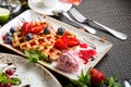 Italian dessert - crispy waffles with ice cream  cream cheese and jam. Pieces of fruit for dessert. Concept - sweet food  obesity Royalty Free Stock Photo