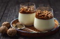 Italian dessert pannacotta in glasses with salted caramel and walnuts. Royalty Free Stock Photo