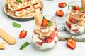 Italian dessert tiramisu cake with fresh strawberry, biscuit and whipped cream and mint on a light background, Vegan lactose free Royalty Free Stock Photo