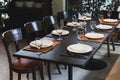Italian dinner table for eight with cutleries, plates, glasses, napkins and naperies on the table. Royalty Free Stock Photo