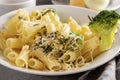Italian dish, plate of pasta , broccoli , spinach, cheese, fork , close up