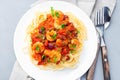 Italian dish shrimp linguine Puttanesca, pasta with shrimps in spicy tomato basil sauce garnished with parsley, on white plate, Royalty Free Stock Photo