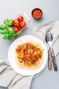 Italian dish shrimp linguine Puttanesca, pasta with shrimps in spicy tomato basil sauce garnished with parsley, on white plate, Royalty Free Stock Photo