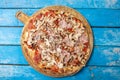 Italian extra large pizza isolated on a shabby blue background