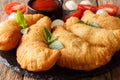 Italian fast food: fried panzerotti with tomato sauce, herbs and Royalty Free Stock Photo