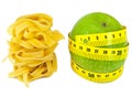 Italian fettuccine nest pasta and apple with a measuring tape on a white background