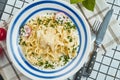 Italian fettuccine pasta in cheese sauce with parmesan, cherry tomatoes and herbs in white ceramic bowl on white background. Tasty Royalty Free Stock Photo