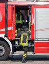 Italian firefighters climb on the trucks of firefighters