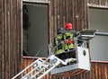 Italian firefighters while rising with the mobile platform to fr