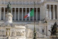 Italian flag on the background of Vittoriano - a monument in honor of the King of Italy Victor