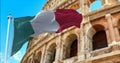 The Italian flag flapping in the wind with the Colosseum blurred in the background Royalty Free Stock Photo