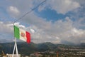 Italian flag with Maltese symbolics against background of hilly terrain. Boeuf-mort, Reunion