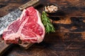 Italian Florentine T-bone beef meat Steak with herbs on a wooden cutting board. Dark wooden background. Top view. Copy Royalty Free Stock Photo