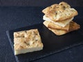 Italian focaccia bread on a black serving plate - several pieces of bread are piled up - breakfast concept Royalty Free Stock Photo