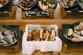 Italian focaccia bread, fried fish pieces, sausages and stewed vegetables in copper pans in the kitchen.