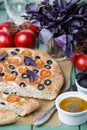 Italian focaccia with tomatoes, black olives and basil Royalty Free Stock Photo