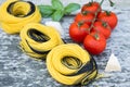 Italian food background with tomatoes, basil, spaghetti, parmesan, olive oil. Ingredients on old wooden table. Royalty Free Stock Photo