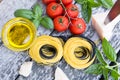 Italian food background with tomatoes, basil, spaghetti, parmesan, olive oil. Ingredients on old wooden table. Royalty Free Stock Photo