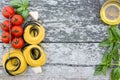 Italian food background with tomatoes, basil, spaghetti, parmesan, olive oil. Ingredients on old wooden table. Royalty Free Stock Photo