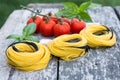 Italian food background with tomatoes, basil, spaghetti, parmesa Royalty Free Stock Photo
