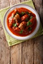 Italian food: beef steak stuffed with parsley and parmesan cheese in tomato sauce close-up on a plate. Vertical top view Royalty Free Stock Photo