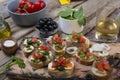 Italian food, bruschettes,tomatoes,basil, cutting board, Delicious snack, appetizer to wine, snack, crostini, fresh, healthy, Royalty Free Stock Photo
