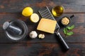 Italian food cooking ingredients for pesto sauce Basil, olive oil, parmesan, garlic, pine nuts. on dark rustic wooden table top Royalty Free Stock Photo