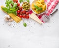 Italian food cuisine and ingredients on white concrete table. Spaghetti Tagliatelle olives olive oil tomatoes parmesan cheese. Royalty Free Stock Photo
