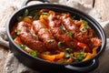 Italian food grilled sausage with grilled peppers, onions, herbs and tomatoes closeup in a frying pan. horizontal Royalty Free Stock Photo