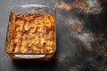 Italian Food. Hot Tasty Freshly Baked Lasagna, in baking tray, on old dark rustic background, with copy space for text Royalty Free Stock Photo